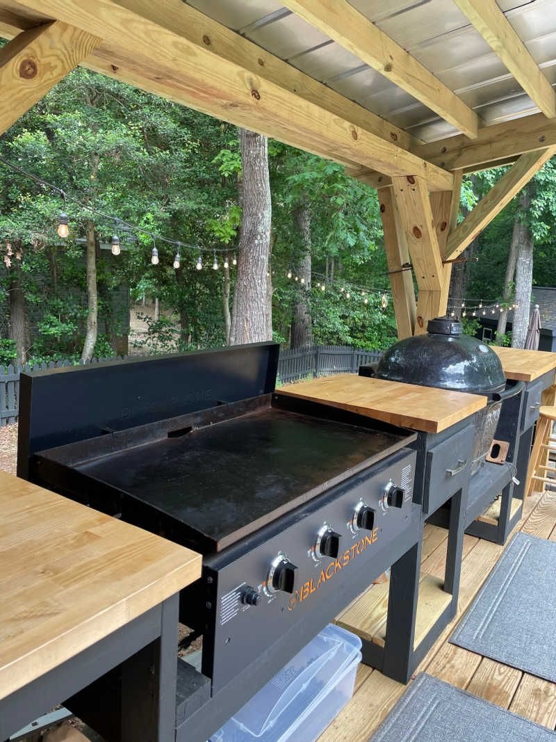 Blackstone griddle integrated into a wooden outdoor kitchen station with light wood countertops.