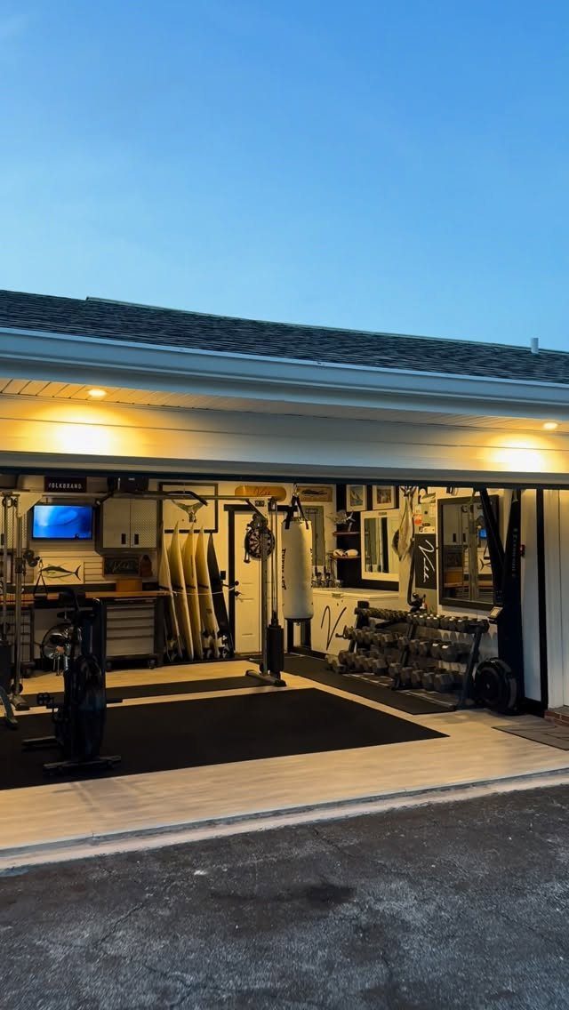 A garage converted into a fitness space with exercise bikes, weights, and a punching bag.